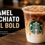 Layered iced caramel macchiato with espresso and caramel drizzle in a clear coffee shop cup