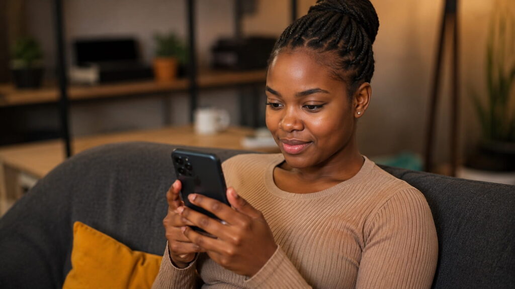 Zambian woman using smartphone to apply for ZamCash loan online in Zambia today in 5 minutes